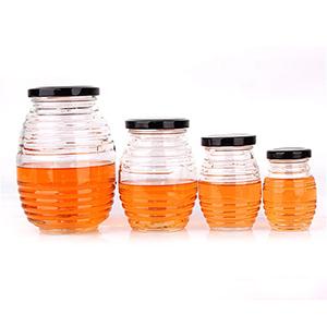 China Bulk Sale Supplier Beehive Honeycomb Shape Honey Glass Jars Bottle with Screw Metal Cap